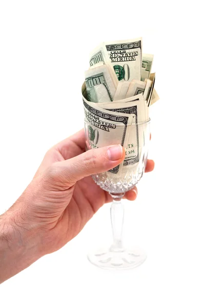 Mão segurando vidro cheio de notas de dólar — Fotografia de Stock