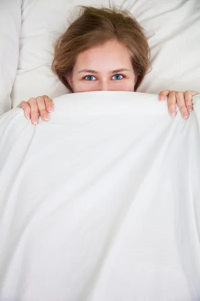 Portrait of young beautiful woman in bed — Stock Photo, Image