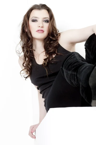 Sitting young woman wearing black clothes — Stock Photo, Image