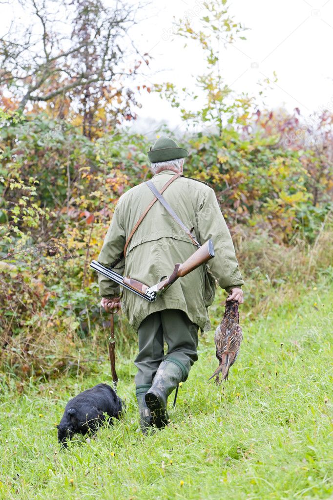 Hunter with a dog at hunt