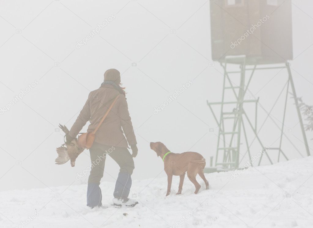 Woman with her dog at hunt