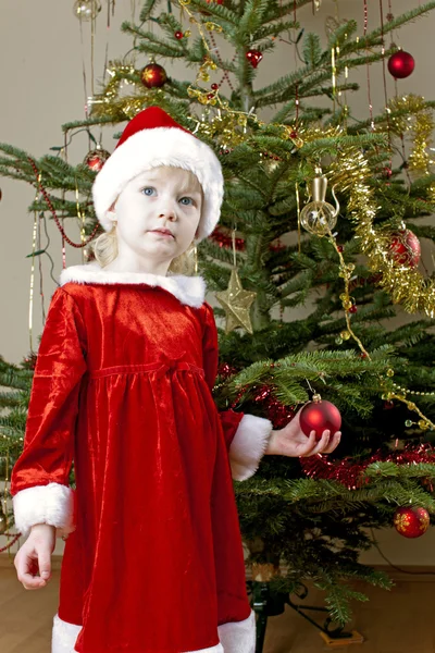 Santa Claus by Christmas tree — Stock fotografie