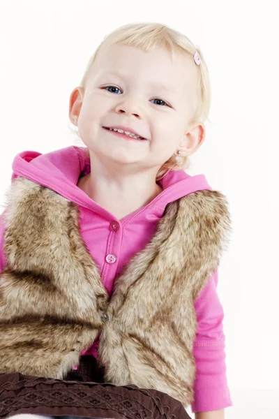 Sitting little girl wearing vest — Stock Photo, Image