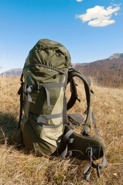 Backpack in mountains clipart