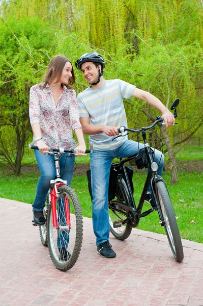 Happy young couple riding bicycles — Stock Photo, Image