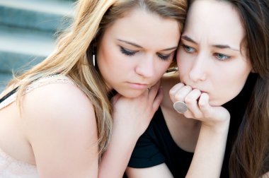 Two sad young beautiful girls clipart