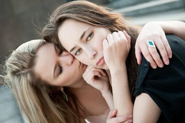 Two sad girls sorry for each other — Stockfoto