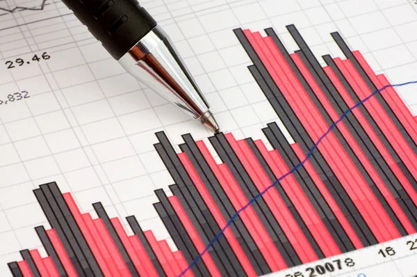 Pen showing diagram on financial report or magazine — Stock Photo, Image
