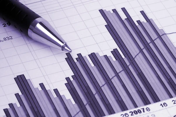 Pen showing diagram on financial report or magazine — Stock Photo, Image