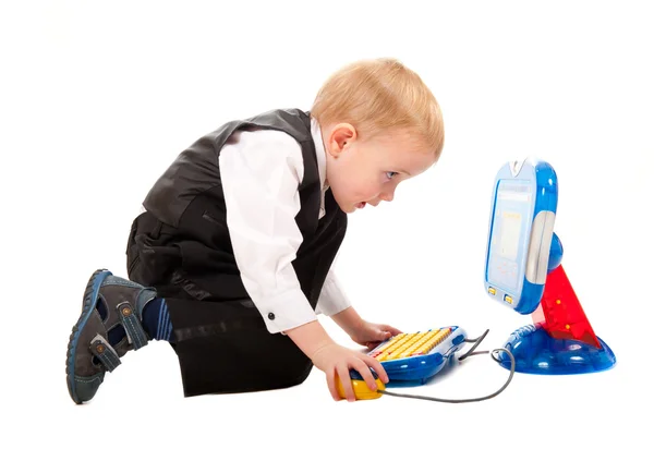 Little boy playing with a toy computer — Stock Photo, Image