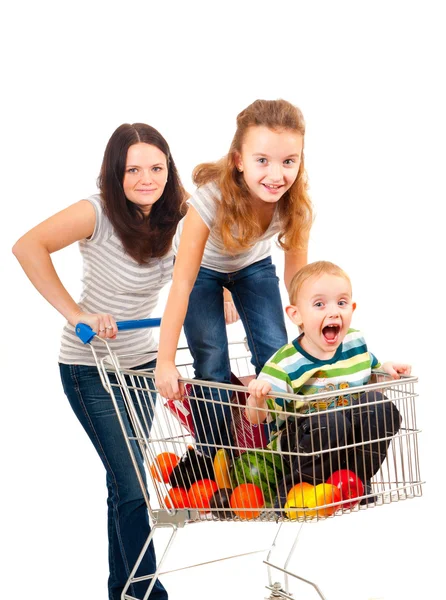 Mother carries her children in a shopping cart — Stock Photo, Image