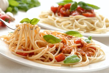 Fork with pasta and basil clipart