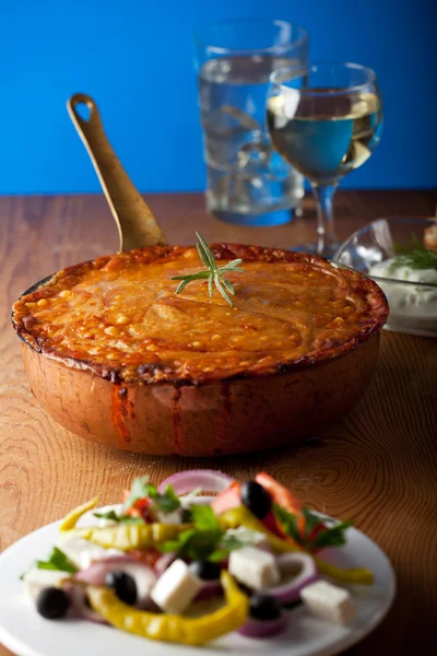 stock image Baked moussaka dish on a wooden board