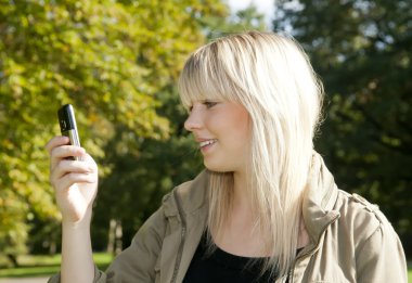 Young woman reading sms clipart