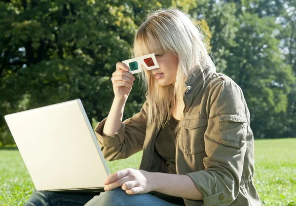 Young woman with 3D-glasses and laptop on a meadow — Stock Photo, Image