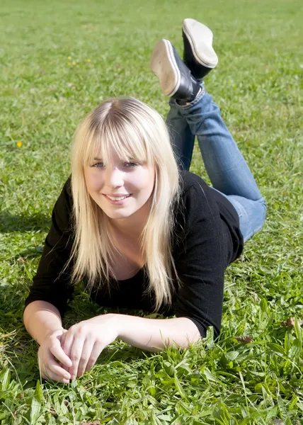 Young woman lying on a meadow — Stock Photo, Image