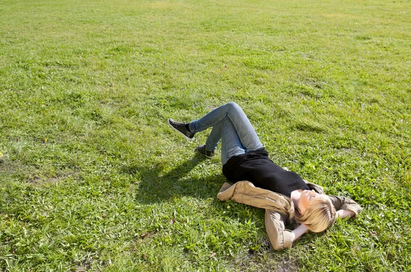 若い女性、草原に横たわっています。 — ストック写真