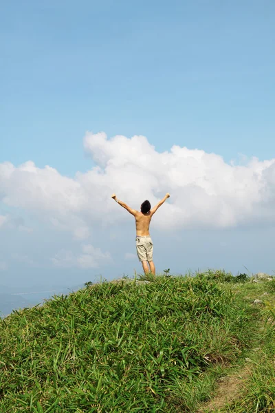 Meeting of the sky. The man on high mountain with the hands lift — Stock Photo, Image