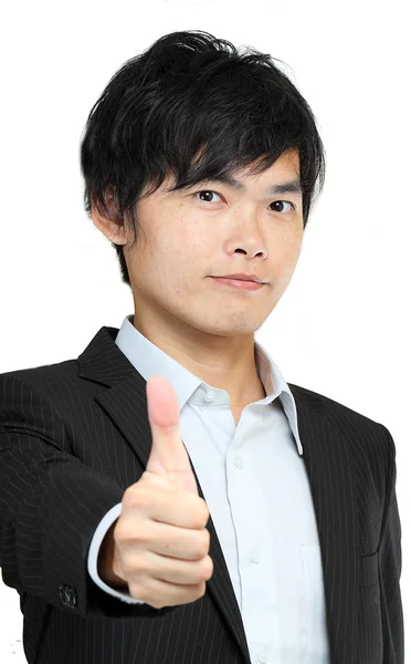 Portret van een jonge man in pak en duimschroef opwaarts — Stockfoto