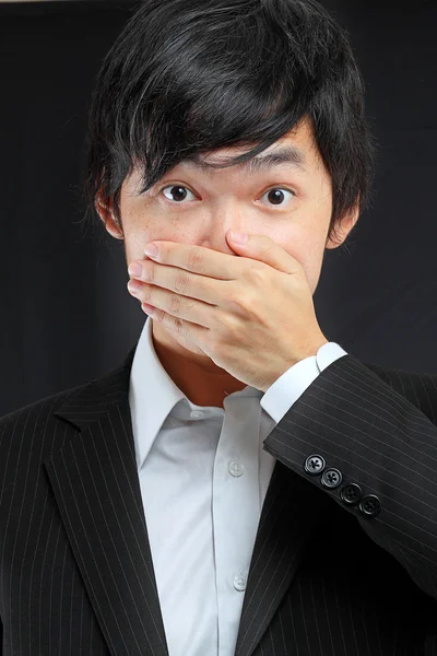 Scared adult man with hand covering mouth — Stock Photo, Image