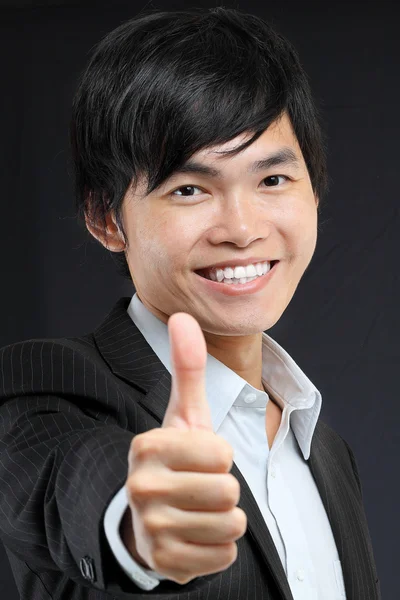 Portrait of young man in suit and thumbs up — Stock Photo, Image