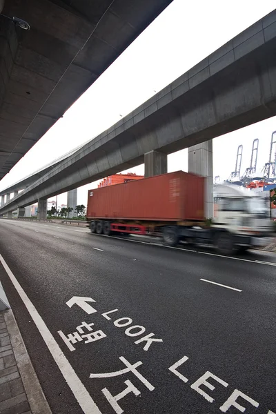Speed container car moving under the overpass — Stock Photo, Image