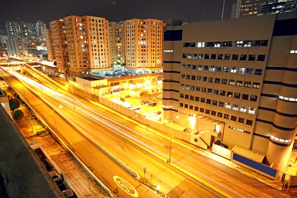 Paisaje urbano de noche y a través del tráfico de la ciudad — Foto de Stock