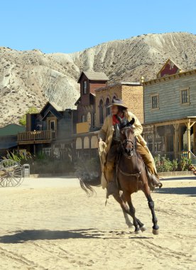 Cowboy on horseback at the Mini Hollywood Movie Set clipart