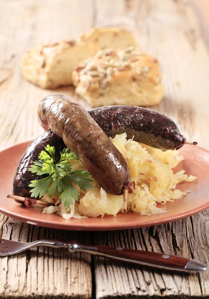 Blood sausage and white pudding with sauerkraut — Stock Photo, Image