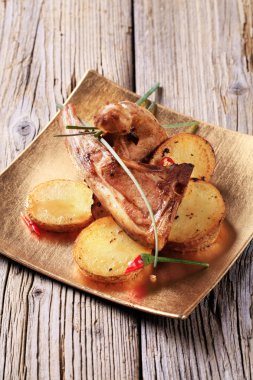 Roast lamb chops and potatoes clipart