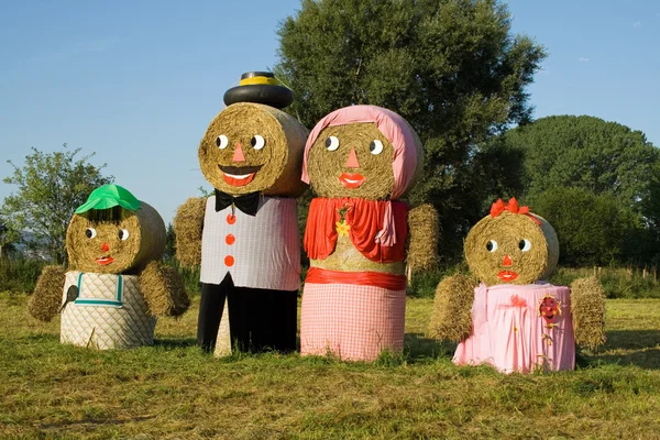 Four figures made out of straw bales — Stock Photo, Image