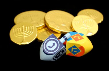 Hanukkah Dreidels and Gelt on Black clipart