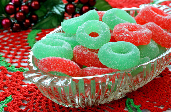 Christmas jelly candy in glass dish on doily.