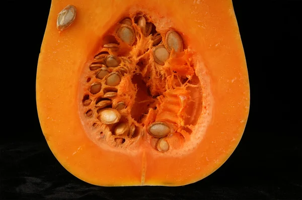Stillife with a fresh pumpkin on black background — Stock Photo, Image