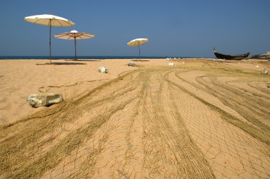 Fishing net on the ocean. Kovalam, Kerala, South India clipart