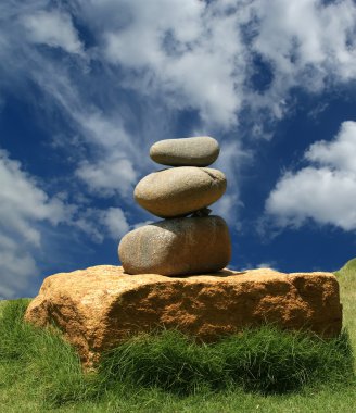 Pile of pebble Stones against the background of palm trees and the sea clipart