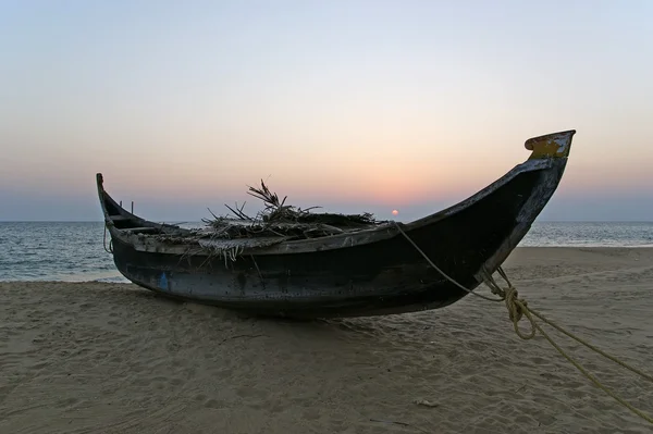 Barco na costa oceânica ao pôr-do-sol. Kerala, Índia — Fotografia de Stock