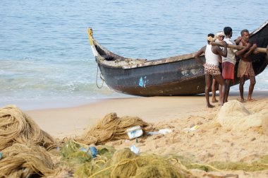 Fishermen in a boat catching fish in the ocean clipart