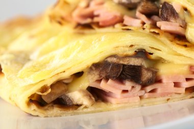 Crepes filled with ham, cheese and mushroom clipart