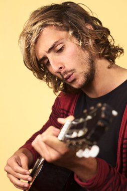 Young Man Playing the Guitar and Whistling clipart