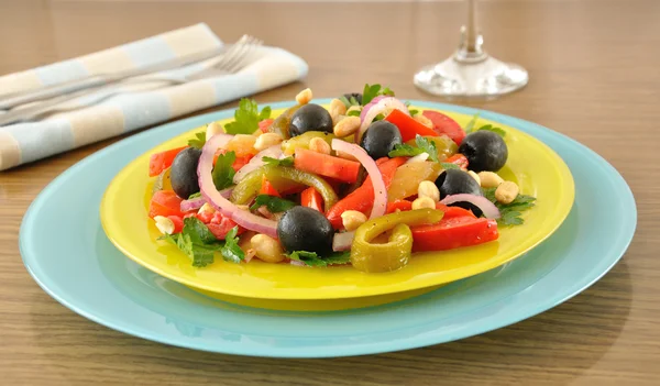 Salad of roasted peppers with tomato, peanuts and olives — Stock Photo, Image