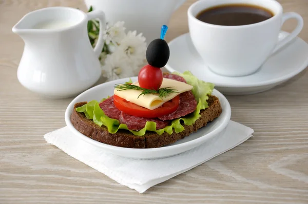 Sandwich with a cup of coffee and milk — Stock Photo, Image