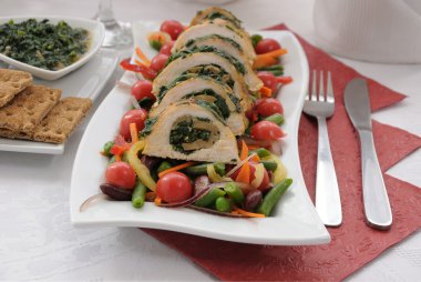 Chicken roulade with spinach and mushrooms with vegetables clipart