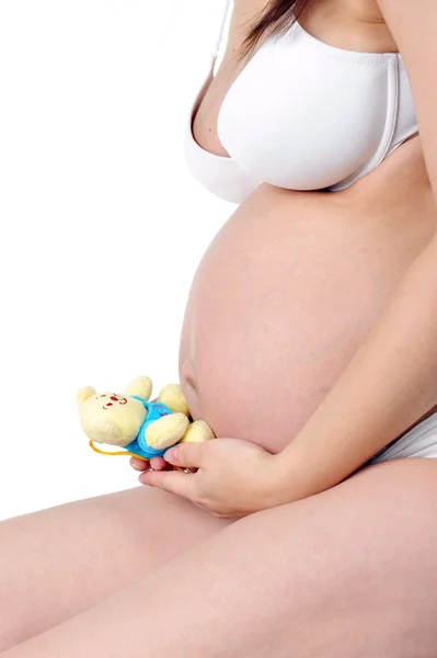 Schwangere mit Kinderspielzeug — Stockfoto