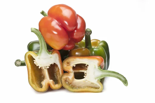 Three peppers and two halves. — Stock Photo, Image