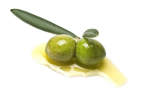 Two green olives on oil. — Stock Photo, Image