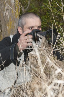 Photographer in a wild environment. clipart