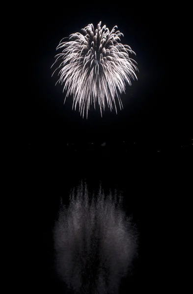 Clear white fireworks on black sky background with water reflect — Stock Photo, Image