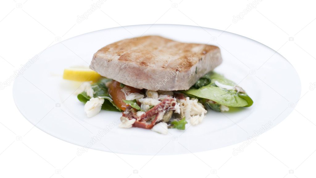 Grilled marinated Ahi tuna salad with crab, baby spinach, dressi