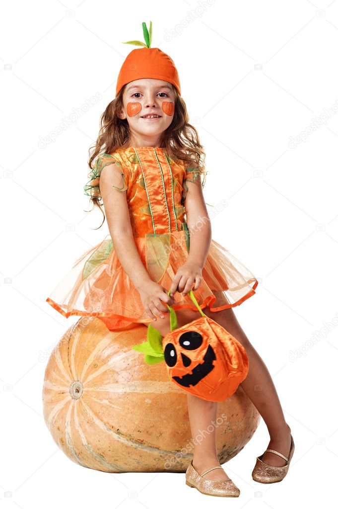 Little girl sits on a pumpkin